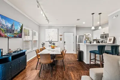 a kitchen and living room with a table and chairs at Luxury 4BR Resort Villa @ Lucaya Village in Kissimmee