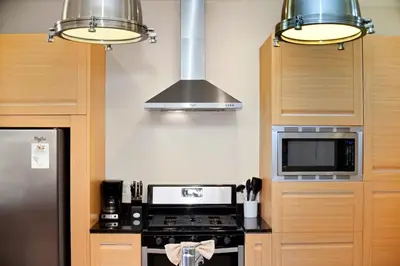 a kitchen with a stove and a microwave at Two Story Resort Retreat Near Theme Parks in Orlando