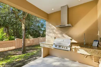 a kitchen with a stove and a counter top at Two Story Resort Retreat Near Theme Parks in Orlando