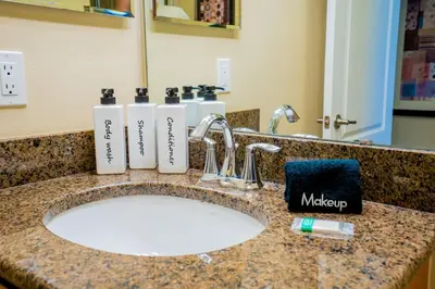 a bathroom sink with two soap dispensers on it at Paradise Found: Private 5-Bed Townhouse Oasis in Kissimmee