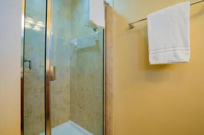 a bathroom with a shower with a glass door at Paradise Found: Private 5-Bed Townhouse Oasis in Kissimmee