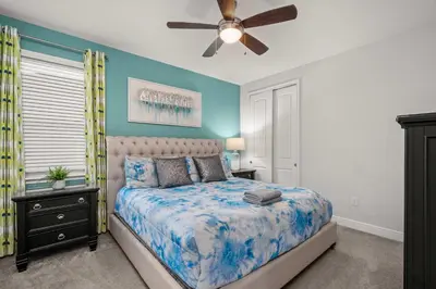 a bedroom with a bed and a ceiling fan at Private Heated Pool Game room 6MI to Disney in Orlando