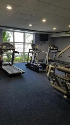 a gym with three treadmills and two ellipticals at Blue Heron Beach Resort Tower 12 FL 1204 Fully Furnished in Orlando