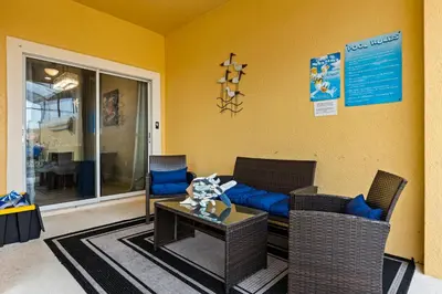 a living room with a couch and chairs and a table at Themed Villa with Private Pool Games Massage Chair in Kissimmee