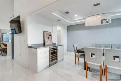 a kitchen and dining room with a table and chairs at Spacious 4BR,3BA Home Near Disney in Kissimmee
