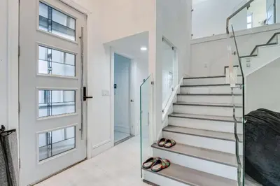 a hallway with stairs and a glass door at Spacious 4BR,3BA Home Near Disney in Kissimmee