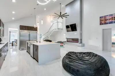a large white kitchen with a large bean bag at Spacious 4BR,3BA Home Near Disney in Kissimmee