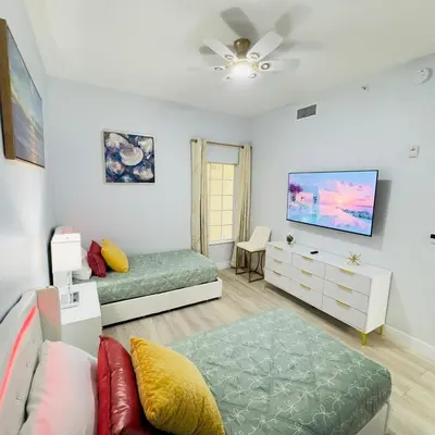 a living room with a couch and a tv at Your Epic Disney Getaway Spacious Home 3BD 3BA in Orlando