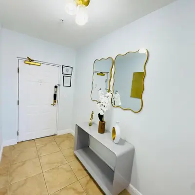 a room with a table and a mirror on the wall at Your Epic Disney Getaway Spacious Home 3BD 3BA in Orlando