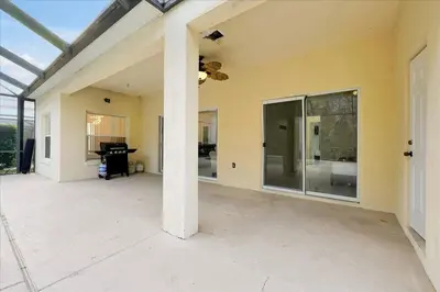 an empty patio with a ceiling fan and a piano at Famous 5 Star Home in Kissimmee with Game Room in Kissimmee