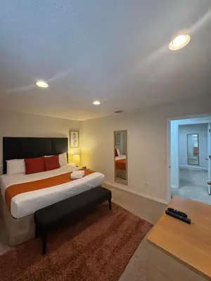 a bedroom with a large bed and a living room at Cosy Family Home in encantada kissimee in Kissimmee