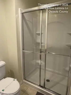 a glass shower in a bathroom with a toilet at Cosy Family Home in encantada kissimee in Kissimmee