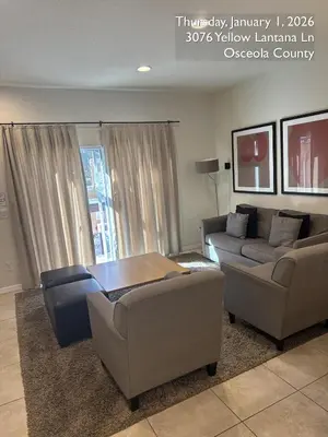 a living room with two couches and a table at Cosy Family Home in encantada kissimee in Kissimmee