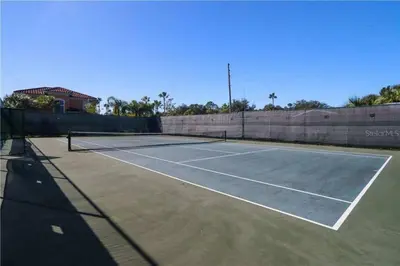 a tennis court with two tennis rackets on it at Casa 3Q no Regal Oaks Resort, Perto da Disney in Orlando
