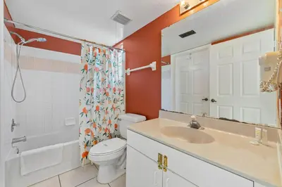 a bathroom with a toilet and a sink and a shower at Mango Keys Getaway Near Theme Parks in Kissimmee