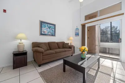 a living room with a couch and a table at Mango Keys Getaway Near Theme Parks in Kissimmee