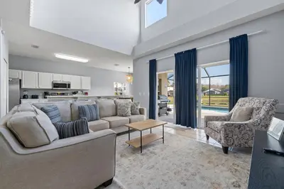 a living room with a couch and a table at Water View Pool Home Near Disney in Kissimmee