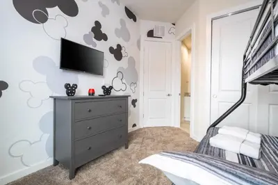 a bedroom with a mickey mouse mural on the wall at 7547 NEW 5 minutes from Disney 5BD 5BH 15P in Orlando