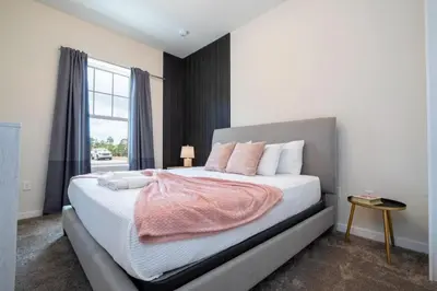 a bedroom with a large bed with a window at 7547 NEW 5 minutes from Disney 5BD 5BH 15P in Orlando