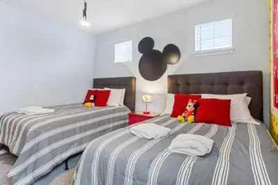 two beds in a bedroom with red and gray stripes at 381 Fantastic Home Near Disney 5BD 5BT 14P in Orlando