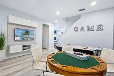 a living room with a table and a game room at 381 Fantastic Home Near Disney 5BD 5BT 14P in Orlando