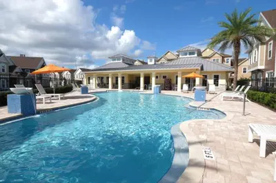 a swimming pool in front of a house at Perfect Home 5 Minutes from Disney 5BD 15P in Orlando