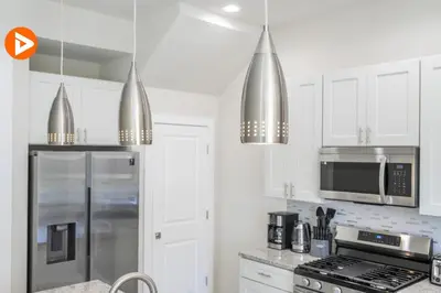 a kitchen with white cabinets and stainless steel appliances at (7556) 3-Bedroom House in Resort near Disney in Orlando