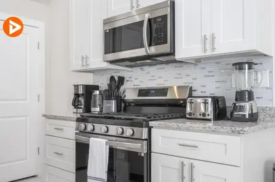 a kitchen with a stove and a microwave at (7556) 3-Bedroom House in Resort near Disney in Orlando