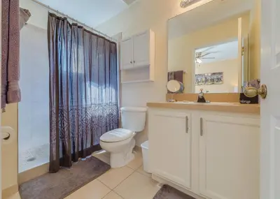a bathroom with a toilet and a sink and a shower at Sun Key Getaway in Kissimmee