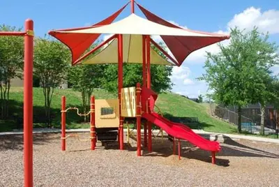 a playground with a red slide and an umbrella at Sun Key Getaway in Kissimmee