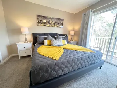 a bedroom with a bed with a yellow blanket on it at Sun Key Getaway in Kissimmee