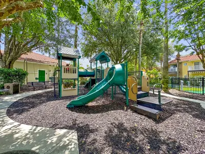 a park with a slide and a playground at Americana at Emerald Island in Kissimmee