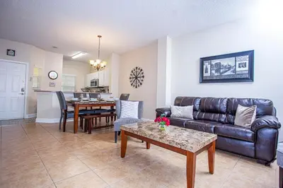 a living room with a couch and a table at Floridian at Emerald Island in Kissimmee
