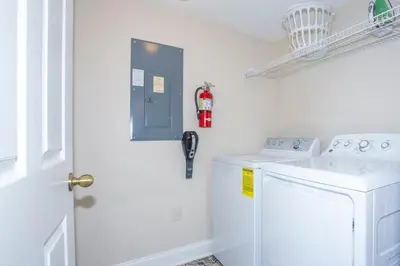 a white laundry room with a washer at Floridian at Emerald Island in Kissimmee