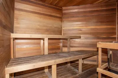 a wooden sauna with a bench in it at Meriggiare at Emerald Island in Kissimmee
