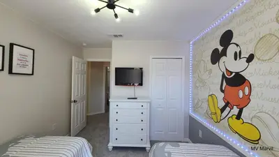 a bedroom with a mickey mouse mural on the wall at Asteria at Emerald Island in Kissimmee