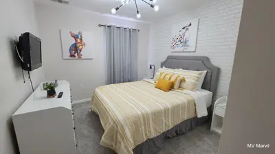 a bedroom with a bed and a television in it at Asteria at Emerald Island in Kissimmee