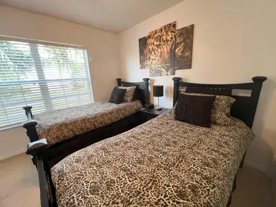 a bedroom with two beds and a window at La Isla at Paradise by PropertyChekker! in Kissimmee