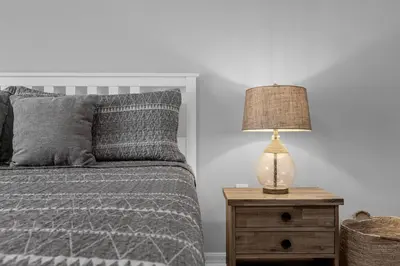 a bedroom with a bed and a lamp on a nightstand at Sunny Side Up in Orlando