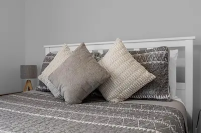 a bed with a bunch of pillows on it at Sunny Side Up in Orlando