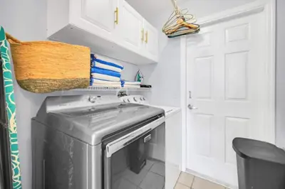 a small kitchen with a washer and dryer at Sunny Side Up in Orlando