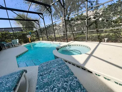 a swimming pool with a bench in front of it at The Haven in Kissimmee