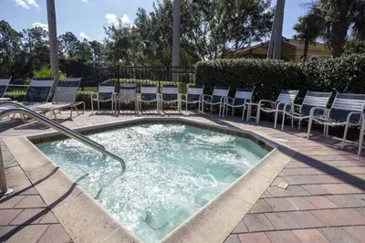 a jacuzzi tub with chairs in a patio at Oasis Key Retreat by PropertyChekker! in Kissimmee