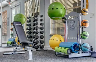 a gym with exercise equipment and balls in it at Apartamento 2 Suítes no Cane Island Resort in Kissimmee