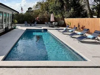 a swimming pool with chaise lounge chairs and a swimming pool at Orlando Villa: Pool Garage & Garden View in Orlando