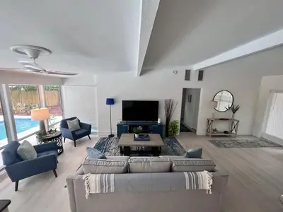 a living room with a couch and a tv at Orlando Villa: Pool Garage & Garden View in Orlando