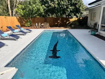 a swimming pool with a mermaid in the middle at Orlando Villa: Pool Garage & Garden View in Orlando