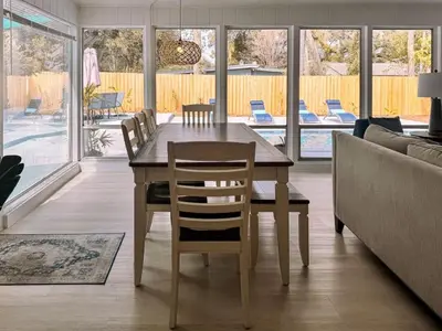 a dining room with a table and chairs and a couch at Orlando Villa: Pool Garage & Garden View in Orlando