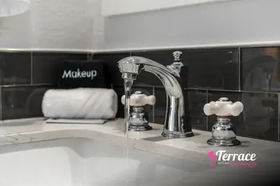 a bathroom sink with water coming from a faucet at Gorgeous 2 Bed 2 Bath Flamingo Penthouse Volcano Bay View in Orlando