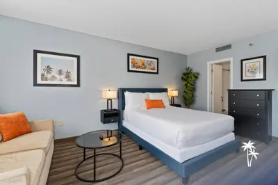 a bedroom with a bed and a couch at Superior Central Condo with Balcony 7 Min to Universal in Orlando
